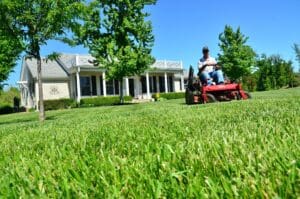 Lawn Care Image of a man on a riding mower